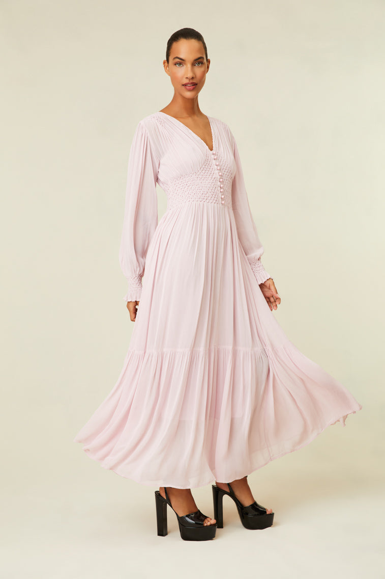 Maxi dress features diamond smocking at the bodice and shoulder.