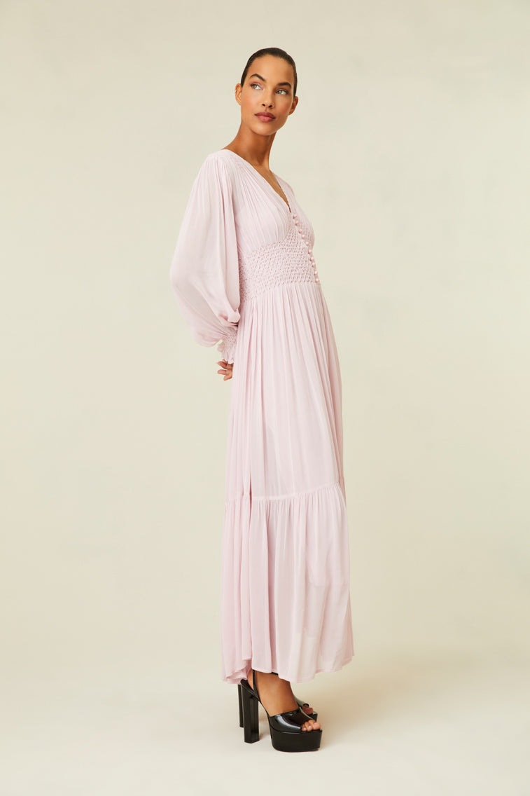 Maxi dress features diamond smocking at the bodice and shoulder.