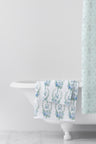 vintage-inspired repeating floral print bath towel in a soft blue against a white back