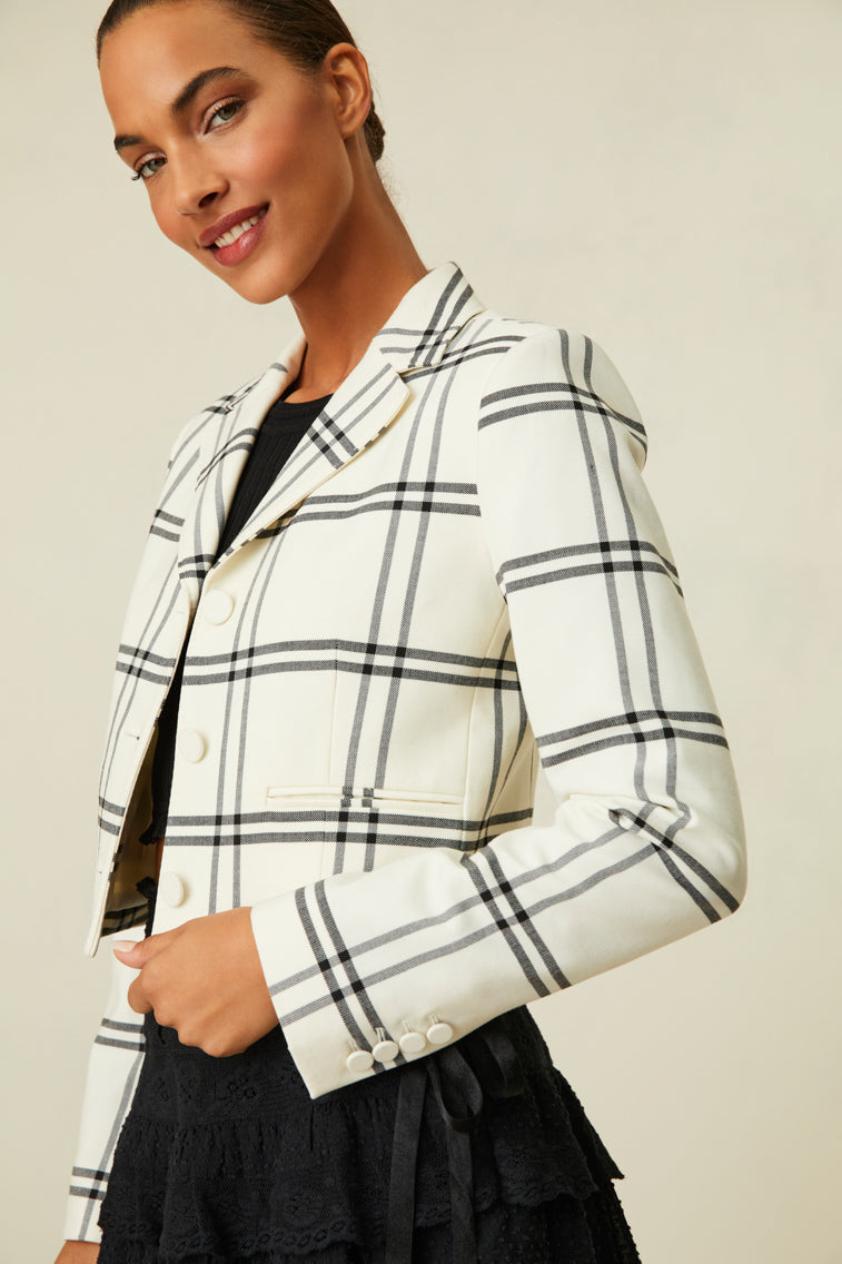 Fitted jacket featuring a chic black and white plaid.