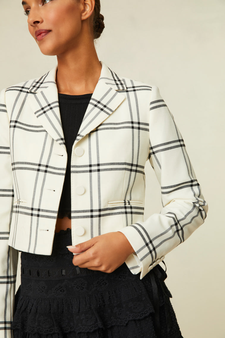 Fitted jacket featuring a chic black and white plaid.