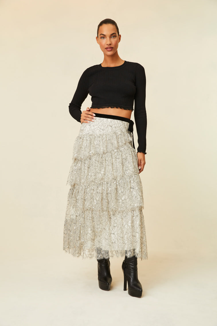 Midi skirt features multi-tiered layers of delicate French lace and a velvet tape ribbon.