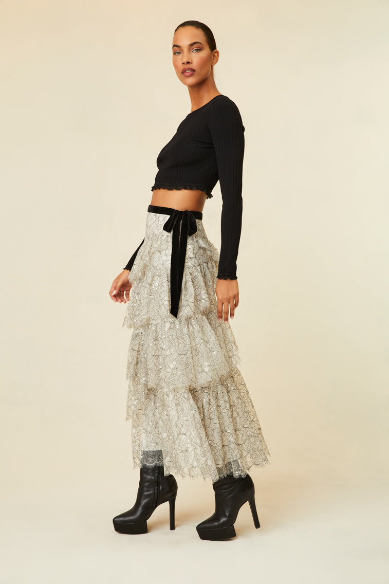 Midi skirt features multi-tiered layers of delicate French lace and a velvet tape ribbon.