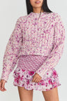 Pink hand-knit crewneck sweater.
