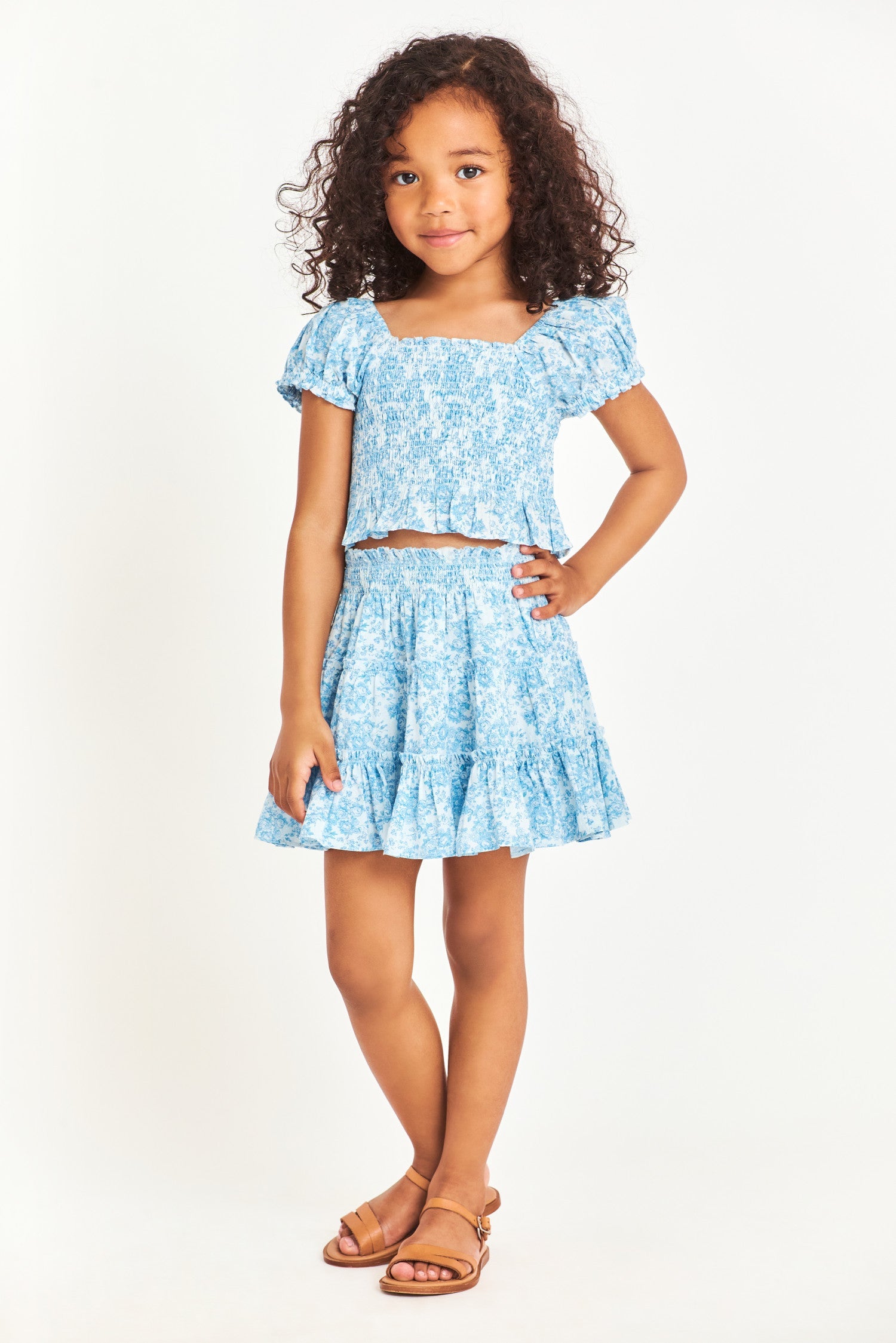 Model wearing kids blue short sleeve top