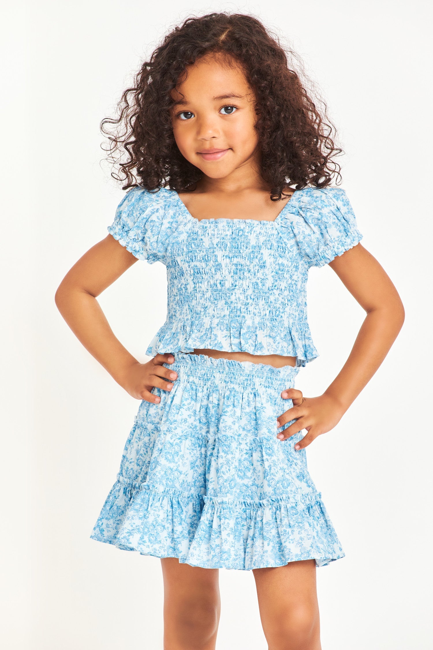 Model wearing kids blue short sleeve top