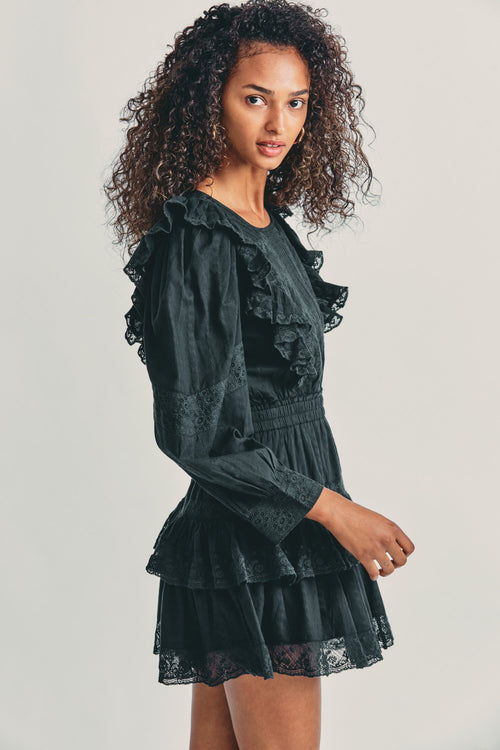 Women's black long sleeve mini dress with lace detail and tapered ruffle princess seam