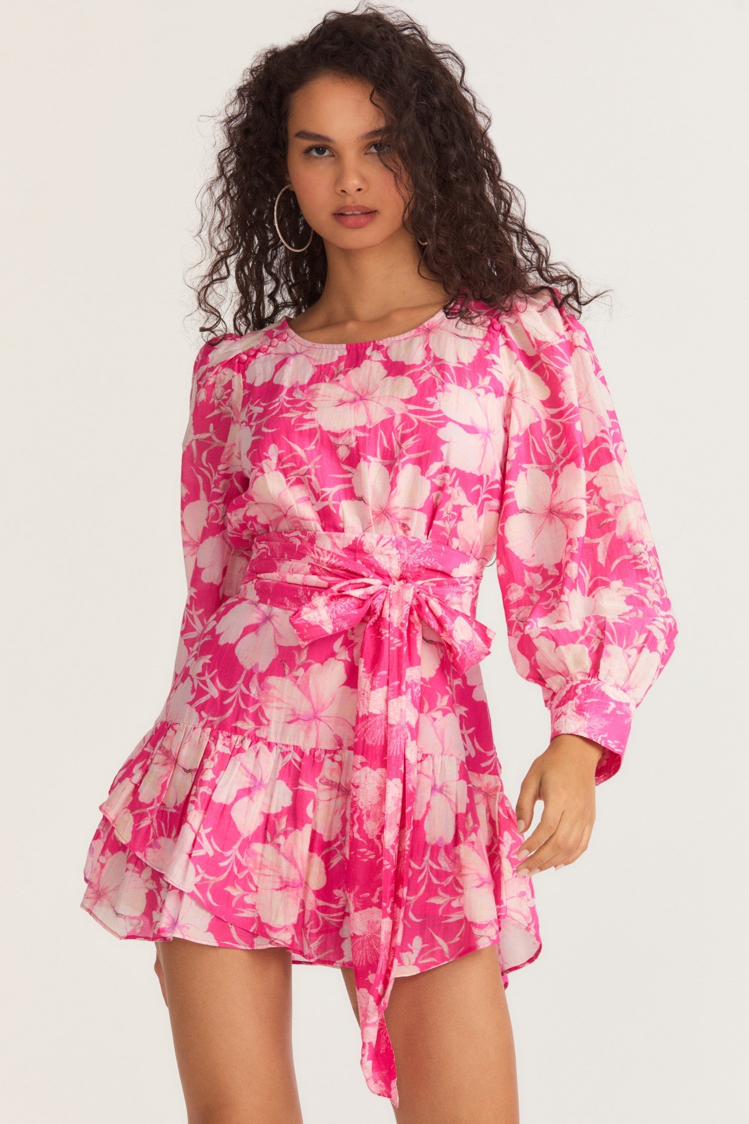 Womens pink floral mini dress with flounce sleeves and sash detail.