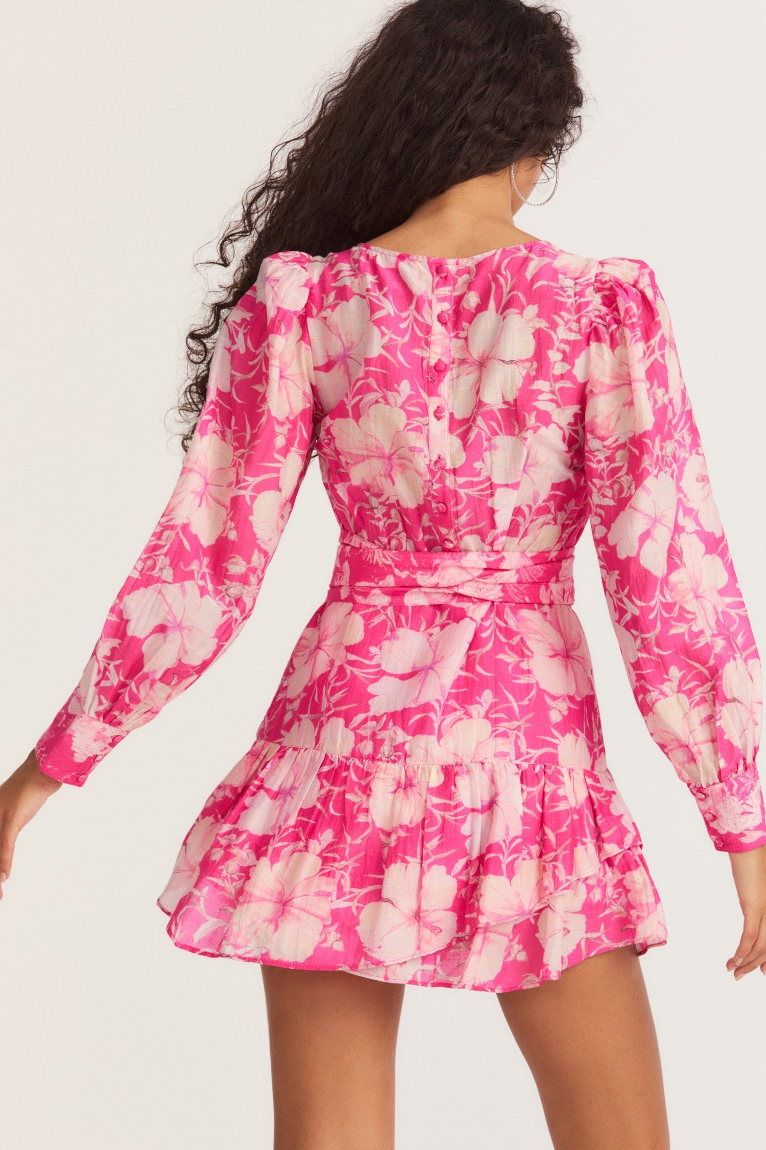 Womens pink floral mini dress with flounce sleeves and sash detail.