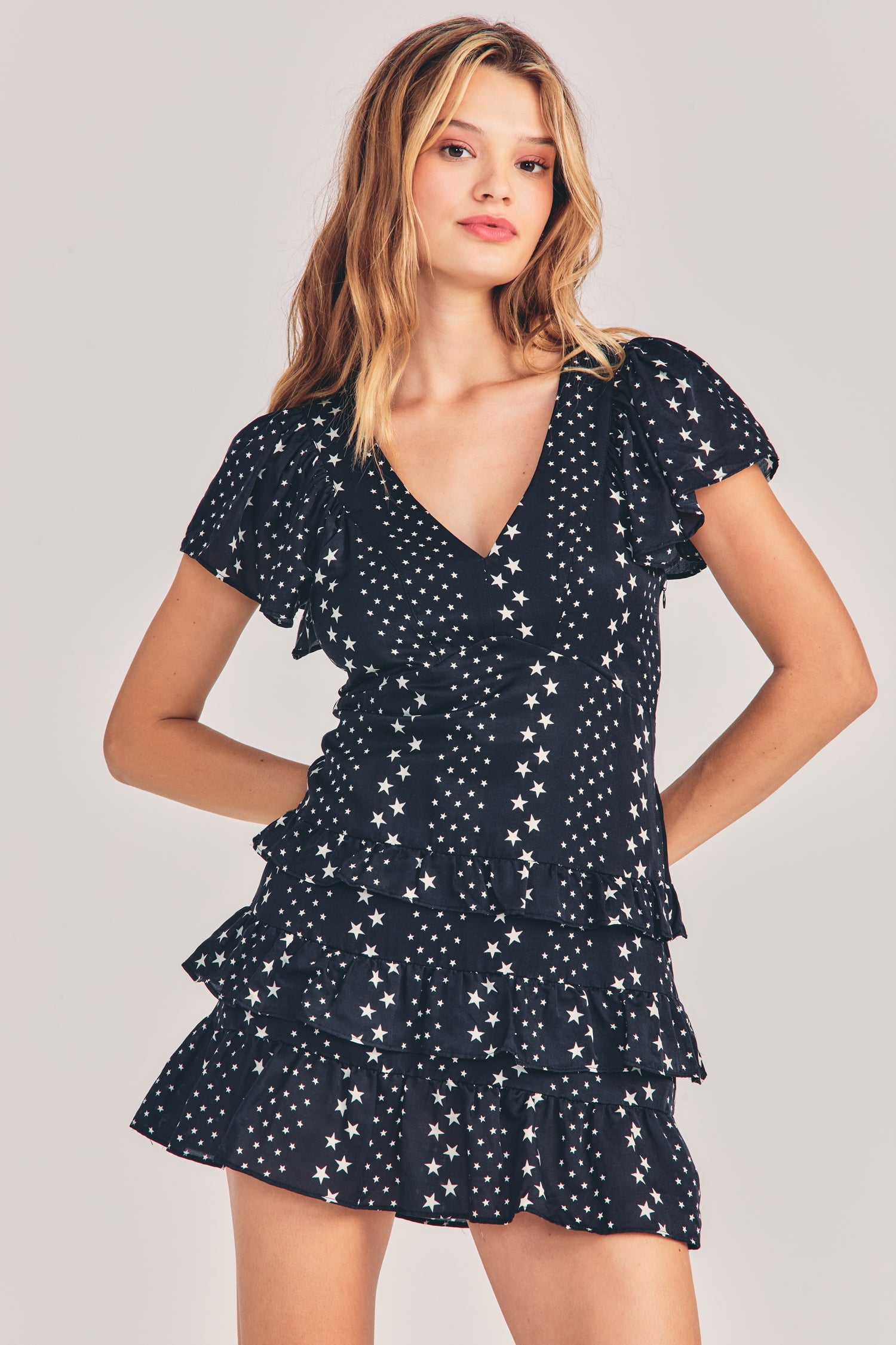 Womens black v-neck mini dress with silver stars and stipes detailing