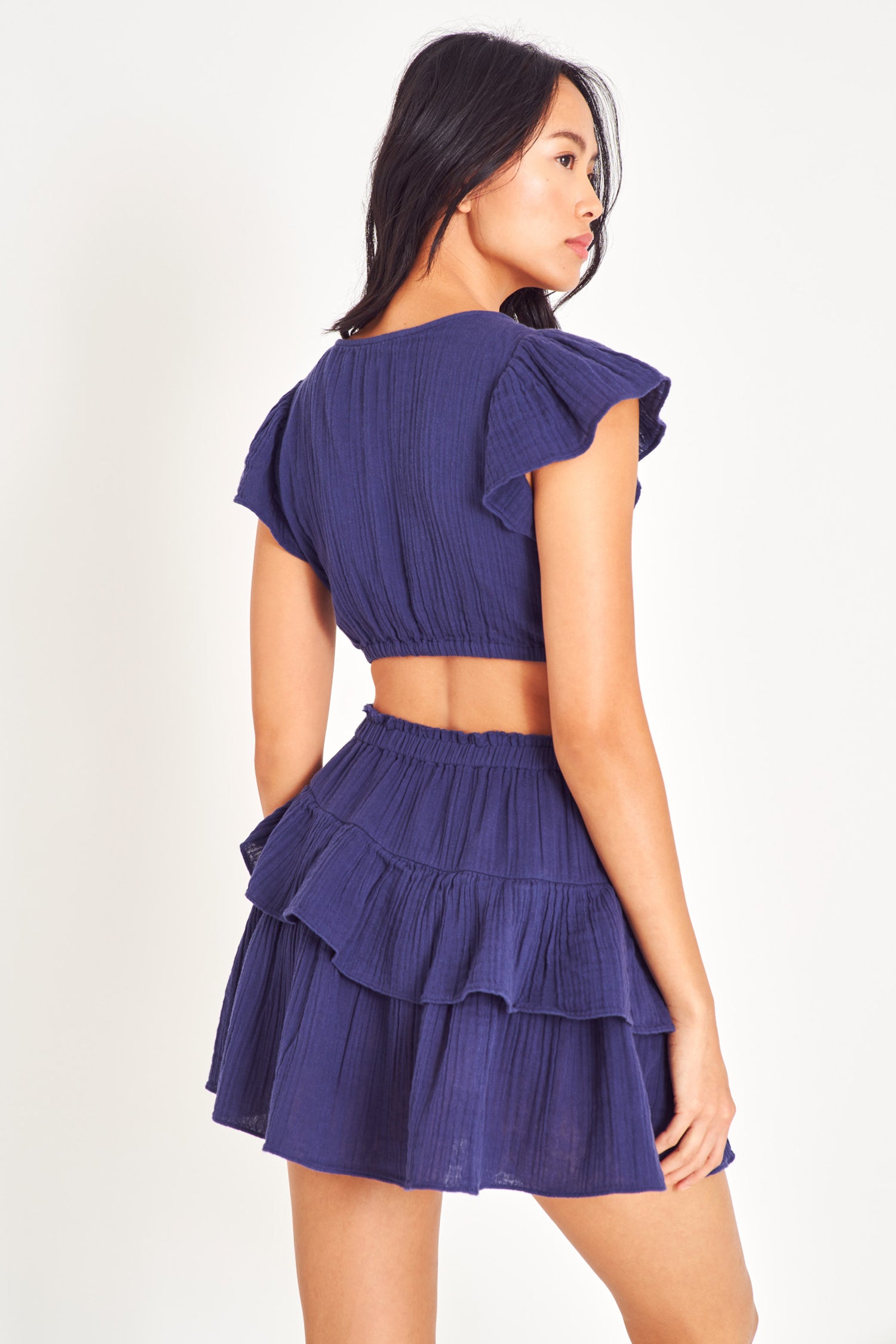 Short sleeve dress with cutouts and a ruffle mini skirt.