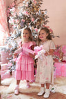 Girls cream floral dress, with sheer puffed sleeves and an empire waist lets down into a full tea-length skirt. Side seam mesh ties extend from the waist to a spirited bow at the back for a sweet touch. Center back button closure.