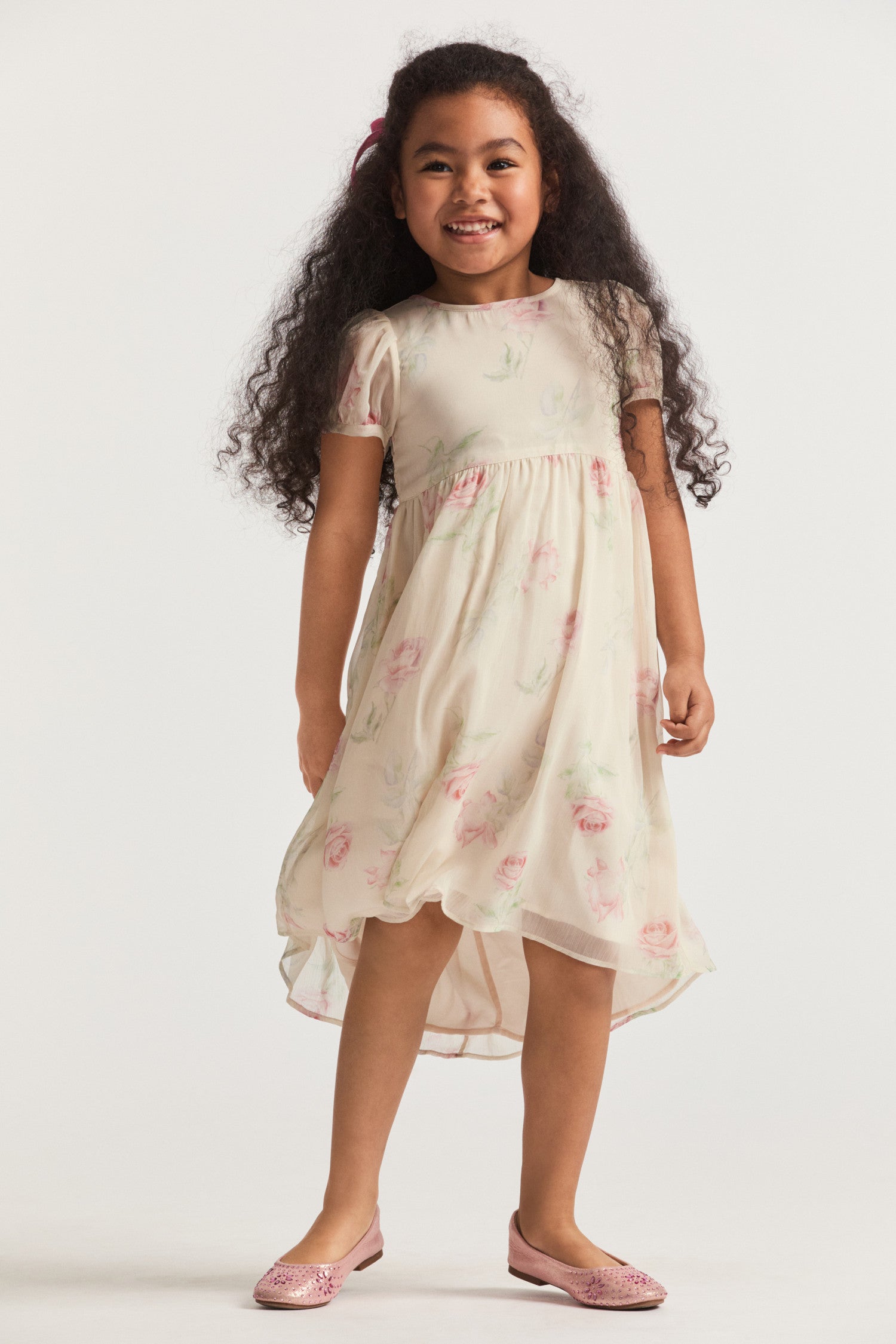 Girls cream floral dress, with sheer puffed sleeves and an empire waist lets down into a full tea-length skirt. Side seam mesh ties extend from the waist to a spirited bow at the back for a sweet touch. Center back button closure.