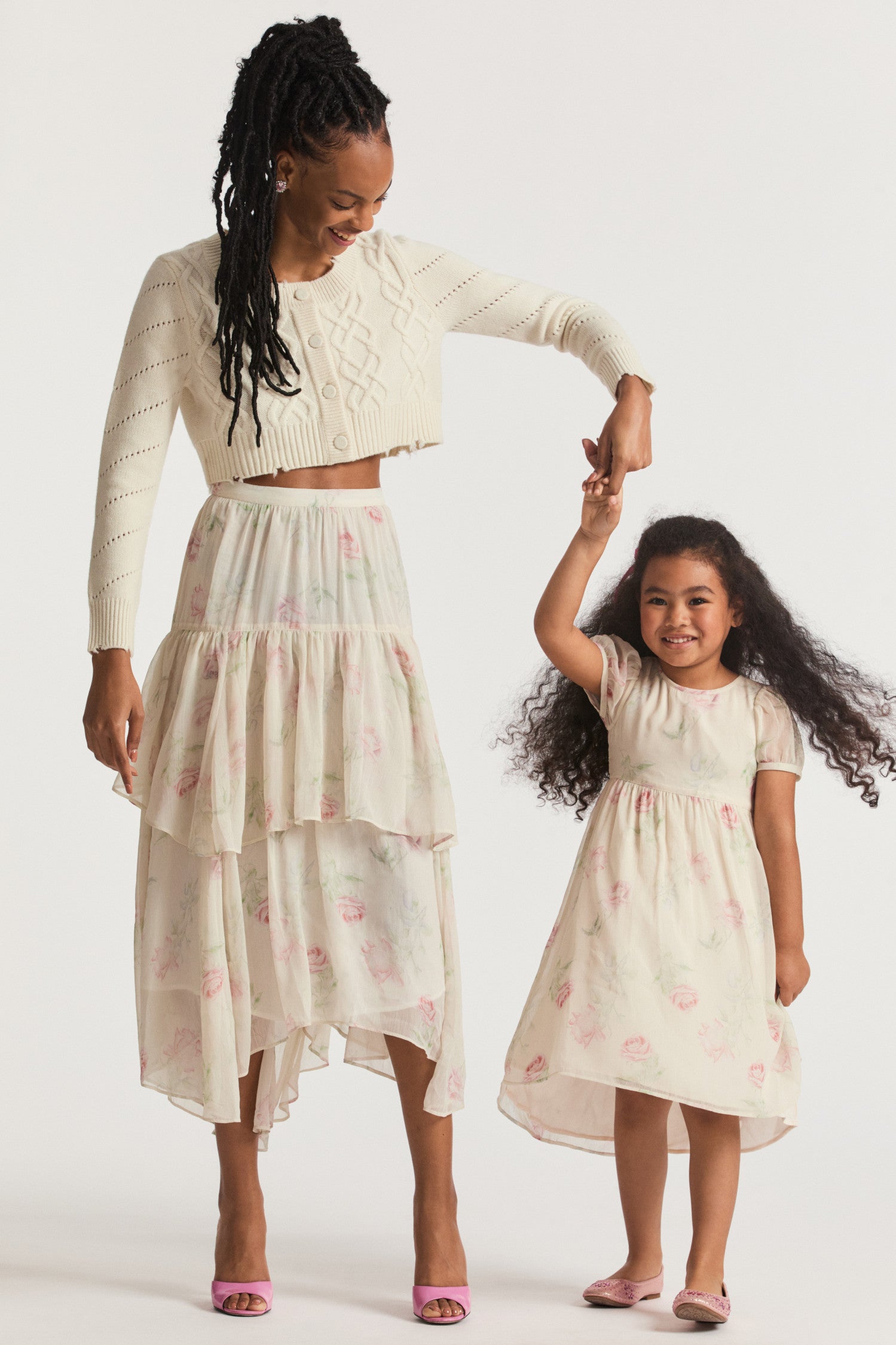 Girls cream floral dress, with sheer puffed sleeves and an empire waist lets down into a full tea-length skirt. Side seam mesh ties extend from the waist to a spirited bow at the back for a sweet touch. Center back button closure.