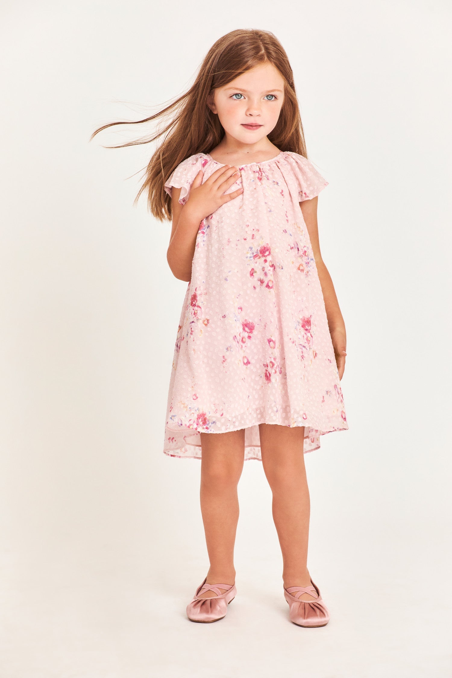 Model wearing kids pink mini dress