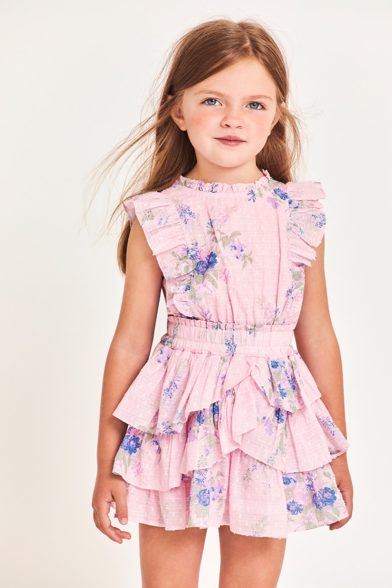 Dress for girls in 100% cotton with custom lace. This easy frock has a ruffle-trimmed collar, buttons down center front, flutter sleeves, an elastic waist and overlapping asymmetrical ruffles at the skirt.