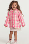Little girl with pink and white houndstooth print wool jacket with pearl buttons, and pockets.