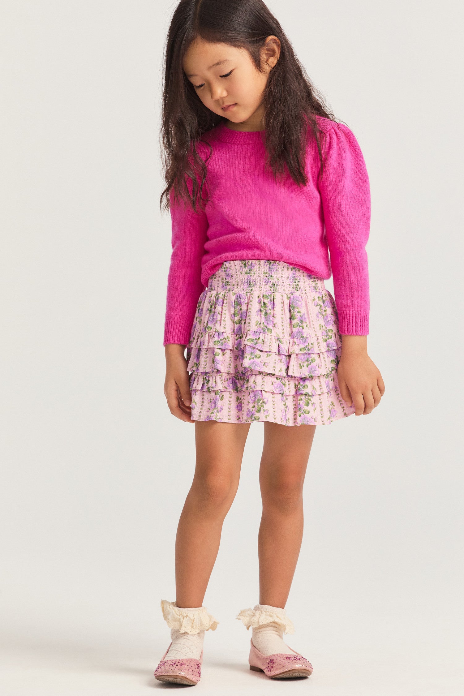 Little girls ruffle mini skirt in a pink flower print.