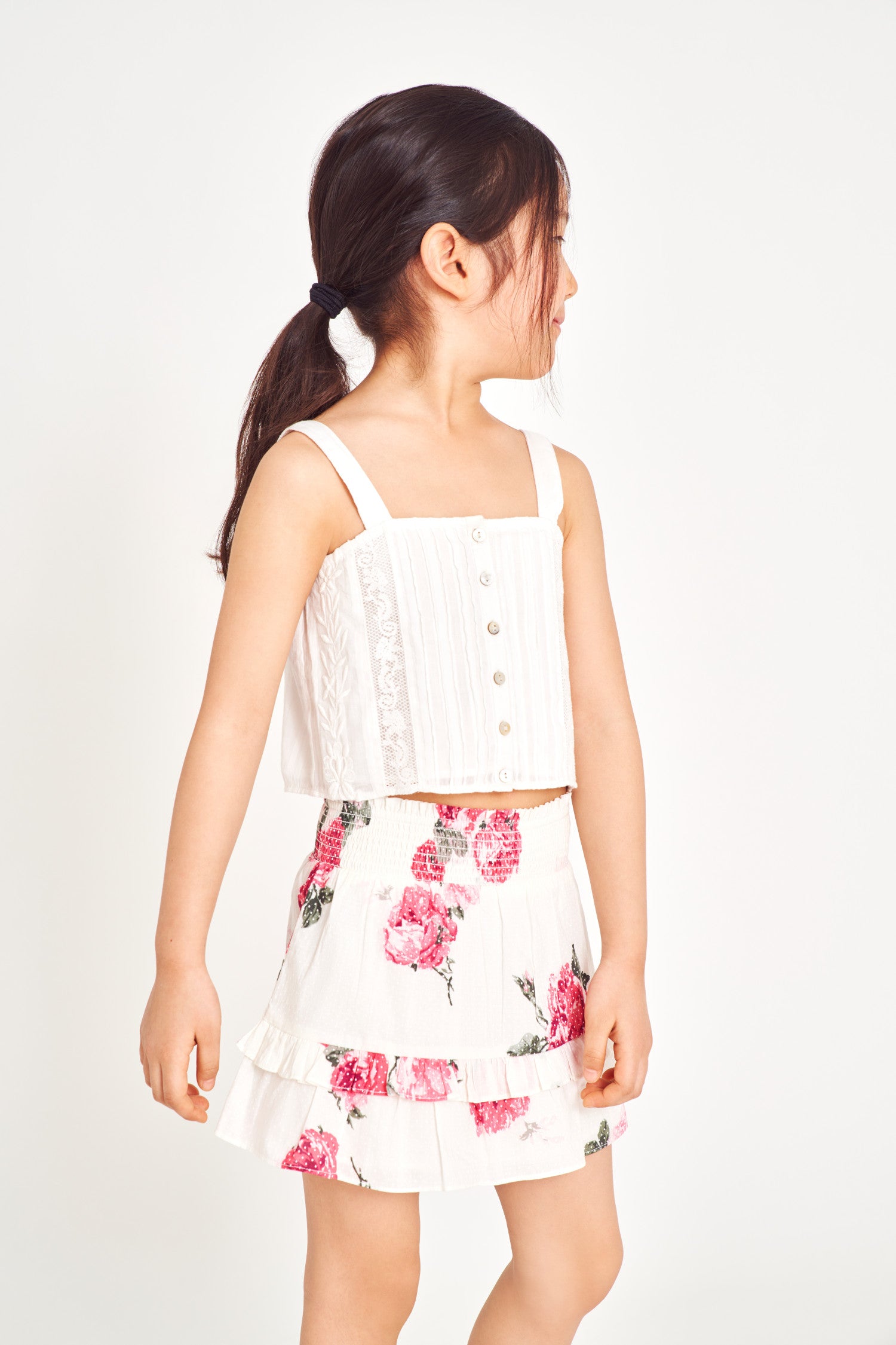 Girls floral mini skirt with smocked waist band and two-tiered ruffle bottom.