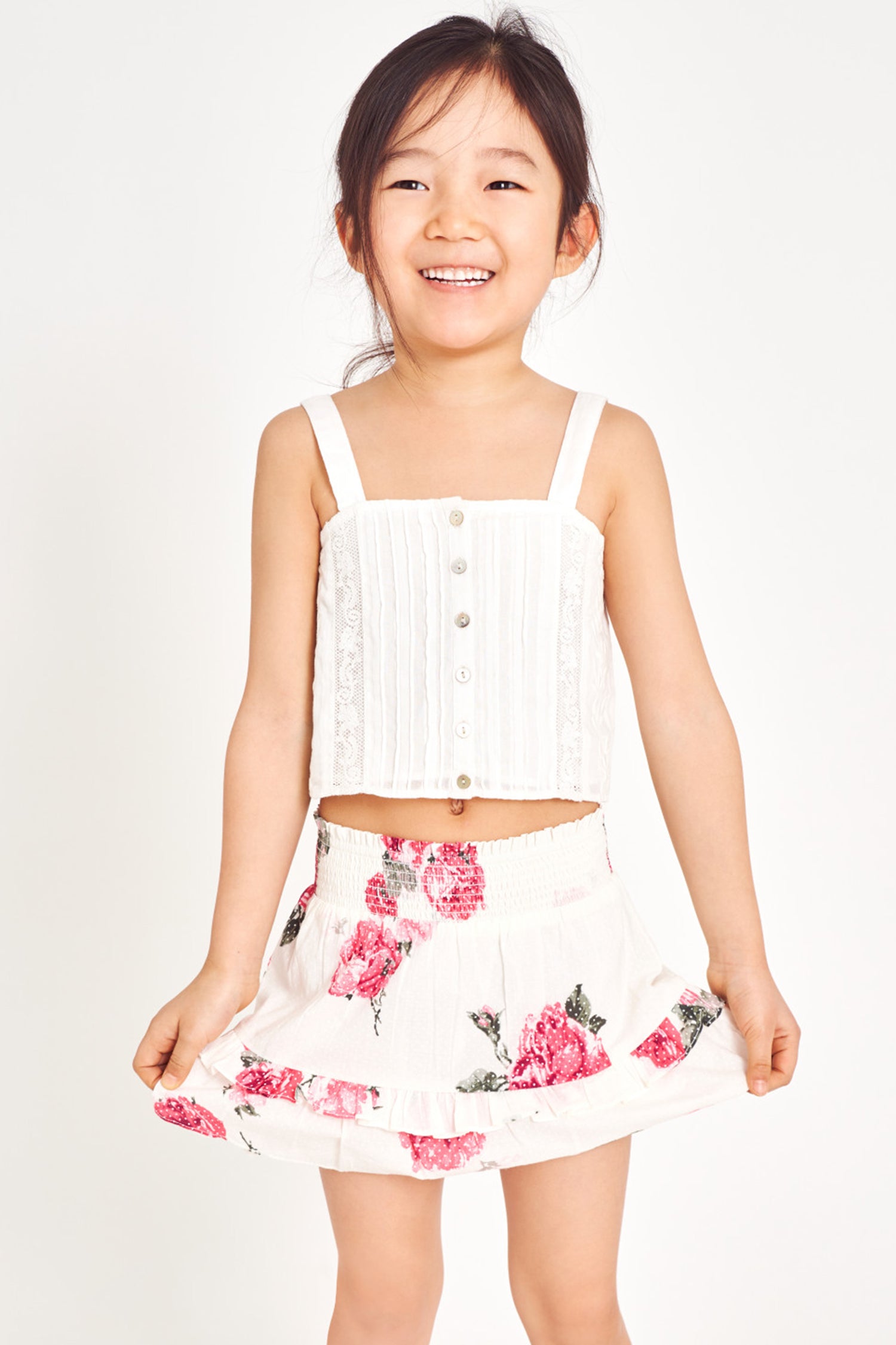 Girls floral mini skirt with smocked waist band and two-tiered ruffle bottom.