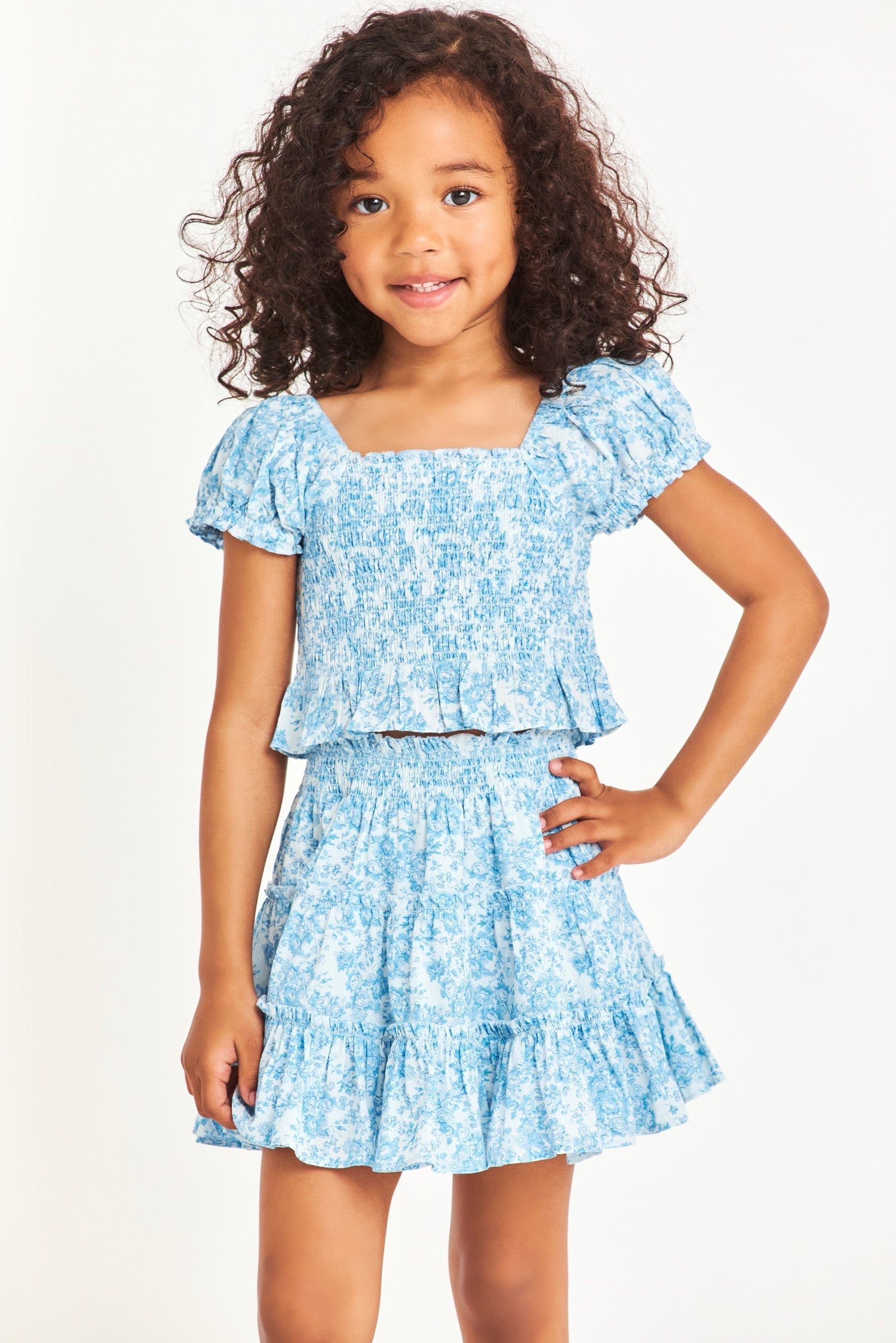 Model wearing kids blue short sleeve top