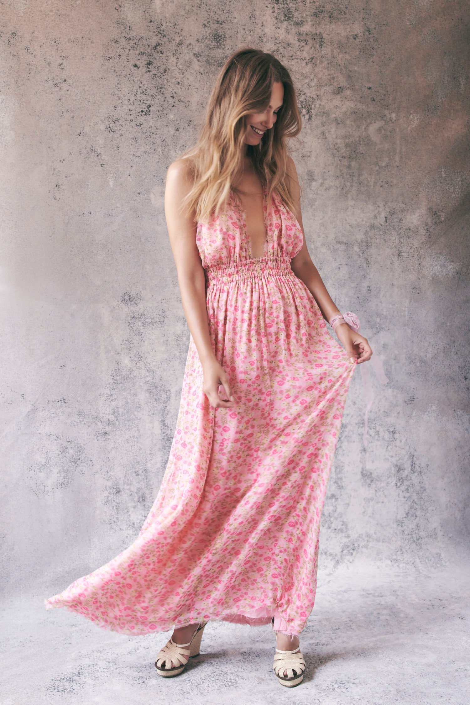 Model wearing pink floral halter maxi dress