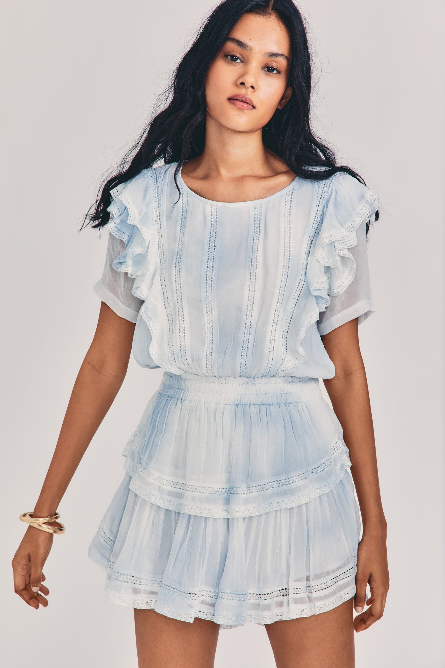 Womens light blue hand-dyes mini dress with ruffle details, a fitted waist, and tiered ruffle skirt