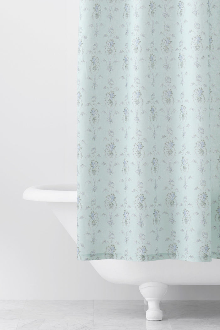 Designed from linen and cotton, its the perfect vintage-inspired shower curtain featuring a blue floral print across the back of a baby blue shower curtain. 
