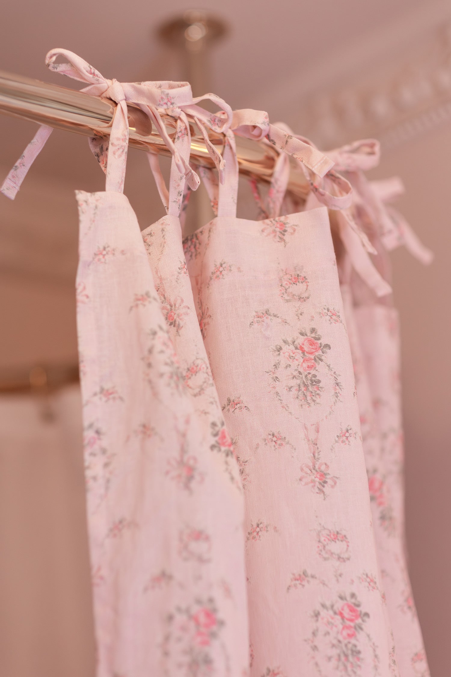 Designed from linen and cotton, its the perfect vintage-inspired shower curtain featuring a pink floral print across the back of a baby pink shower curtain. 