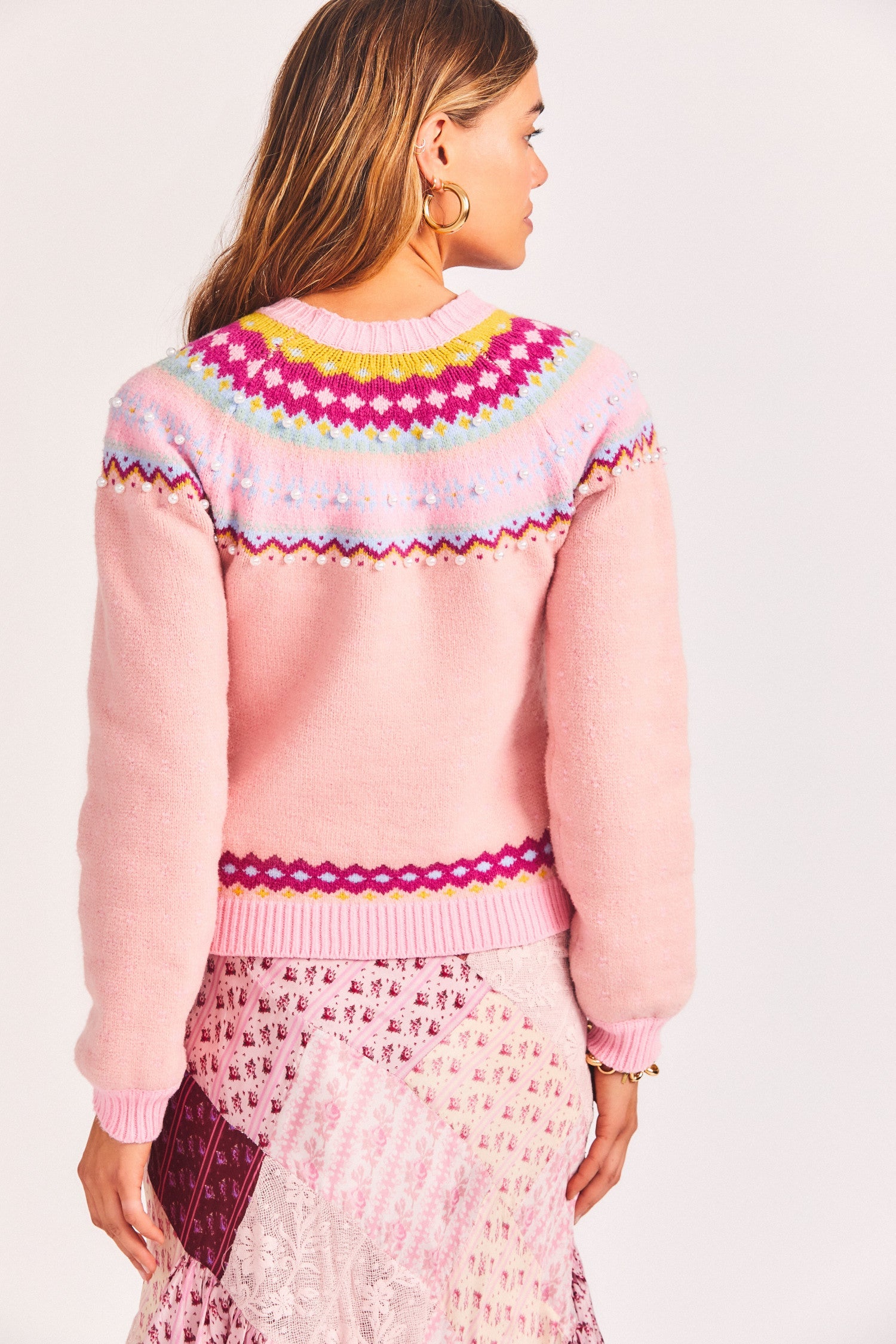 Women's light pink pullover sweater with patterned neckline