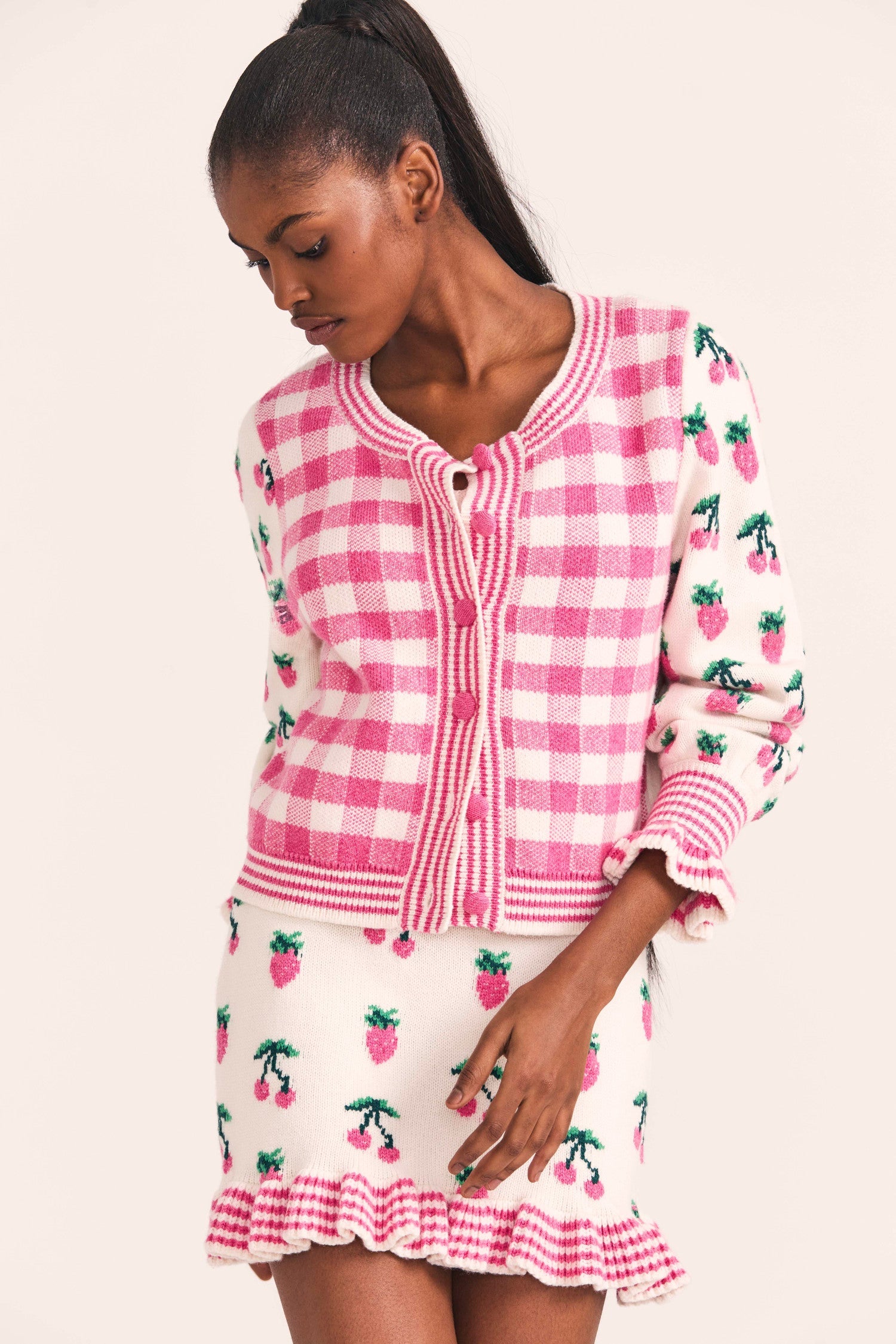 Women's button up sweater with check pattern and strawberry print sleeves