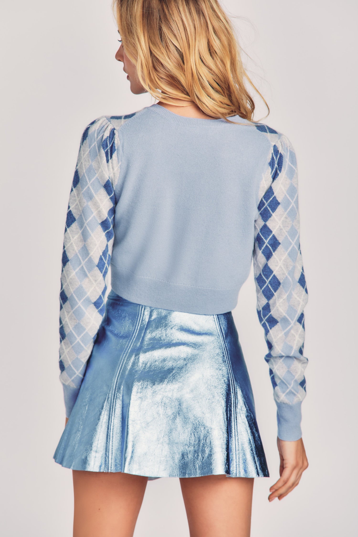 Shiny blue metallic mini skirt with a fixed waist and princess seam detailing