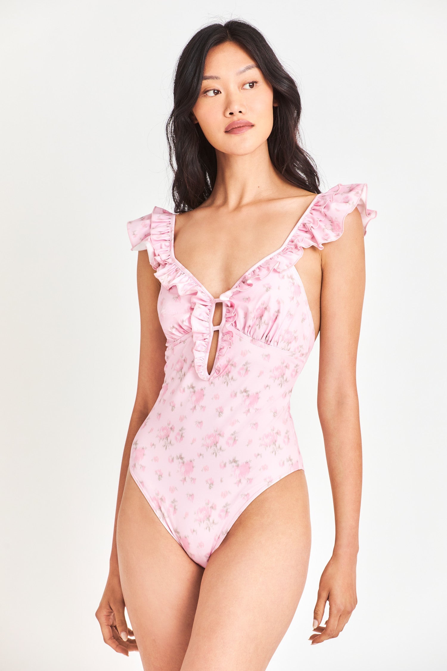 Pink floral one piece swimsuit with ruffle around shoulders/neckline.