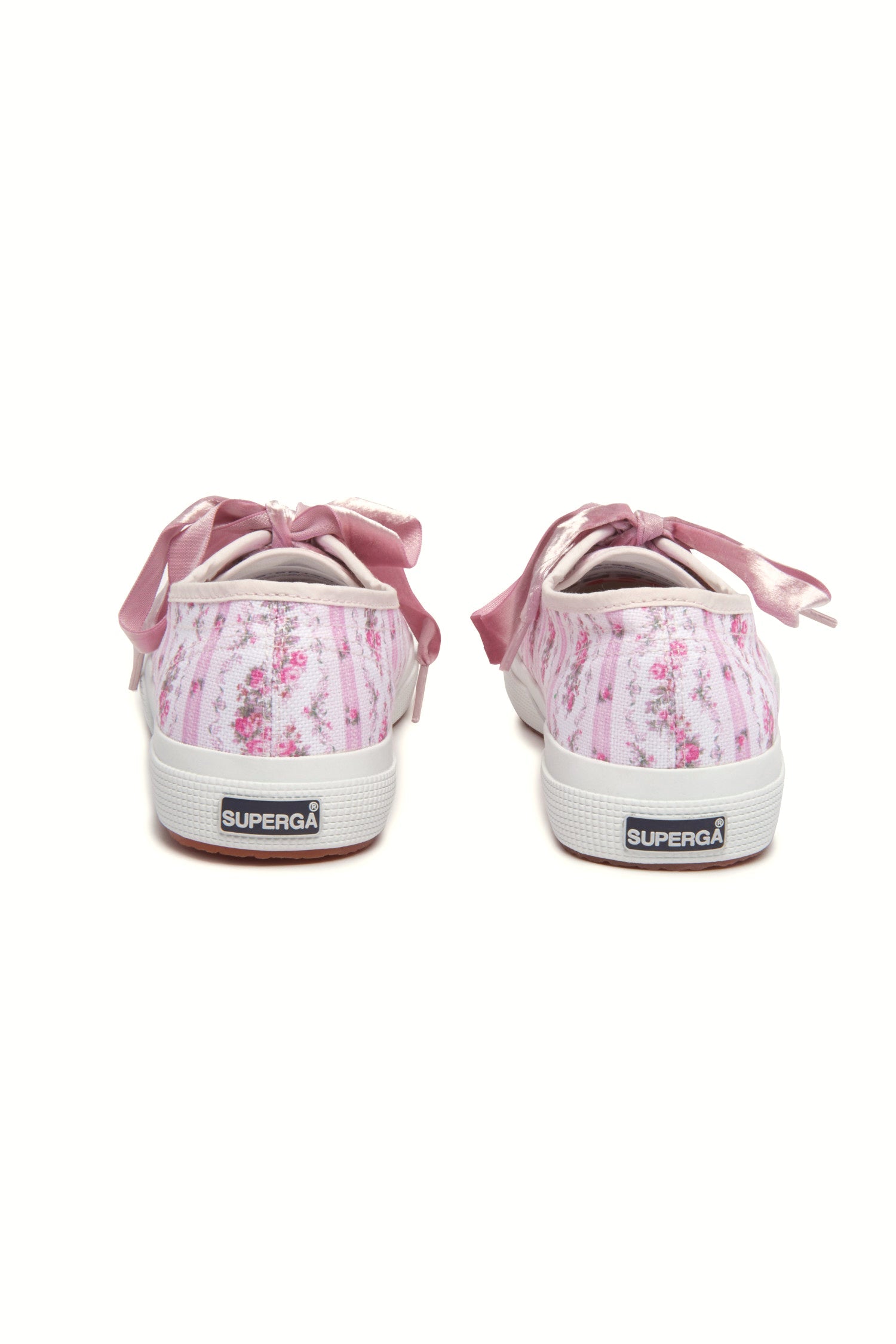 Pastel pink sneaker with floral pattern on printed cotton, gold-toned eyelet details, and pink velvet laces.