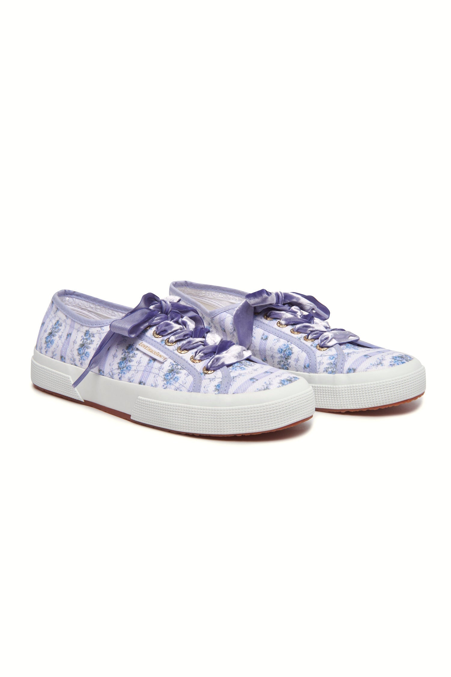 Pastel purple/lilac sneaker  with floral pattern on printed cotton, gold-toned eyelet details, and purple velvet laces.