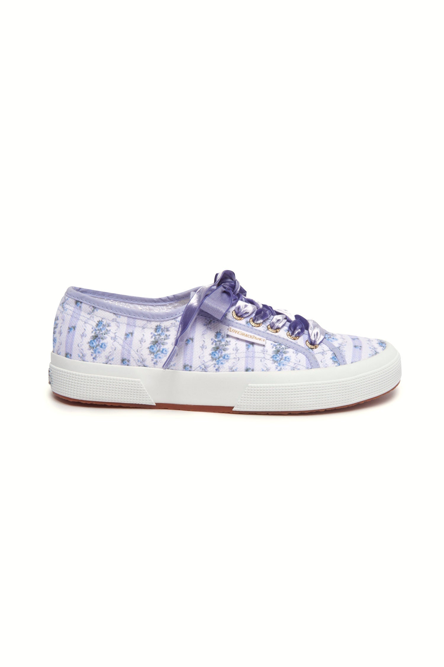 Pastel purple/lilac sneaker with floral pattern on printed cotton, gold-toned eyelet details, and purple velvet laces.