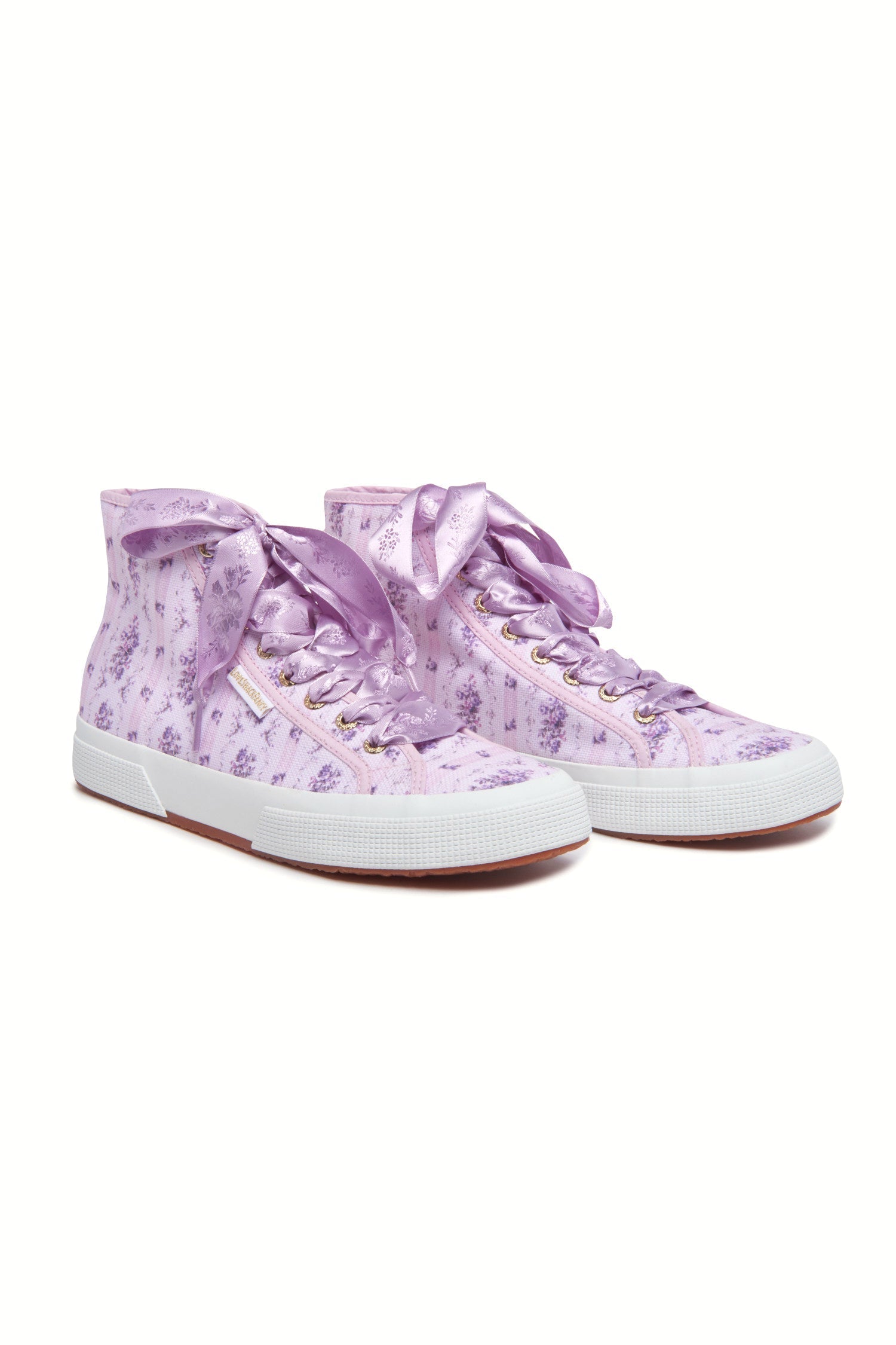 Purple hightop sneakers with florals on printed cotton with purple satin laces, and gold-tone eyelet details.