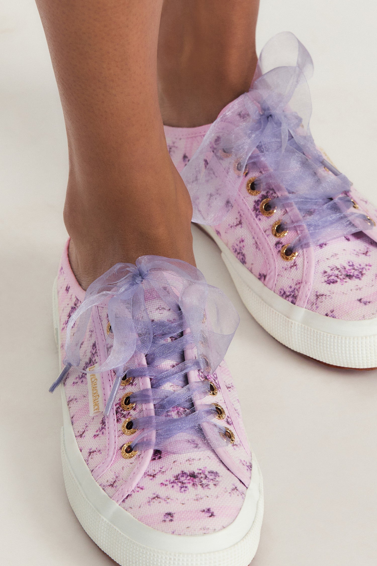 Purple mule sneakers with florals on printed cotton with purple tulle laces, and gold-tone eyelet details.