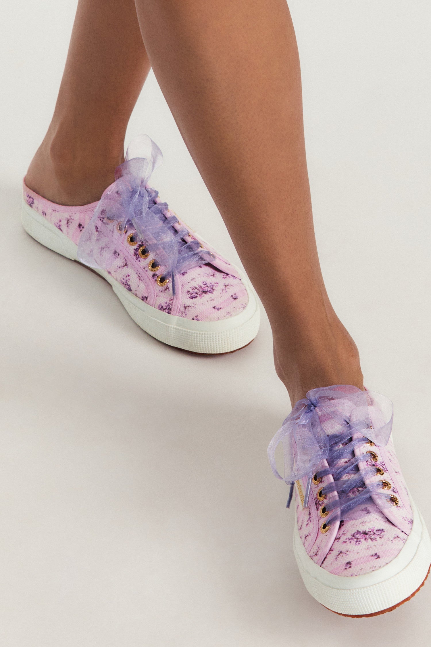 Purple mule sneakers with florals on printed cotton with purple tulle laces, and gold-tone eyelet details.