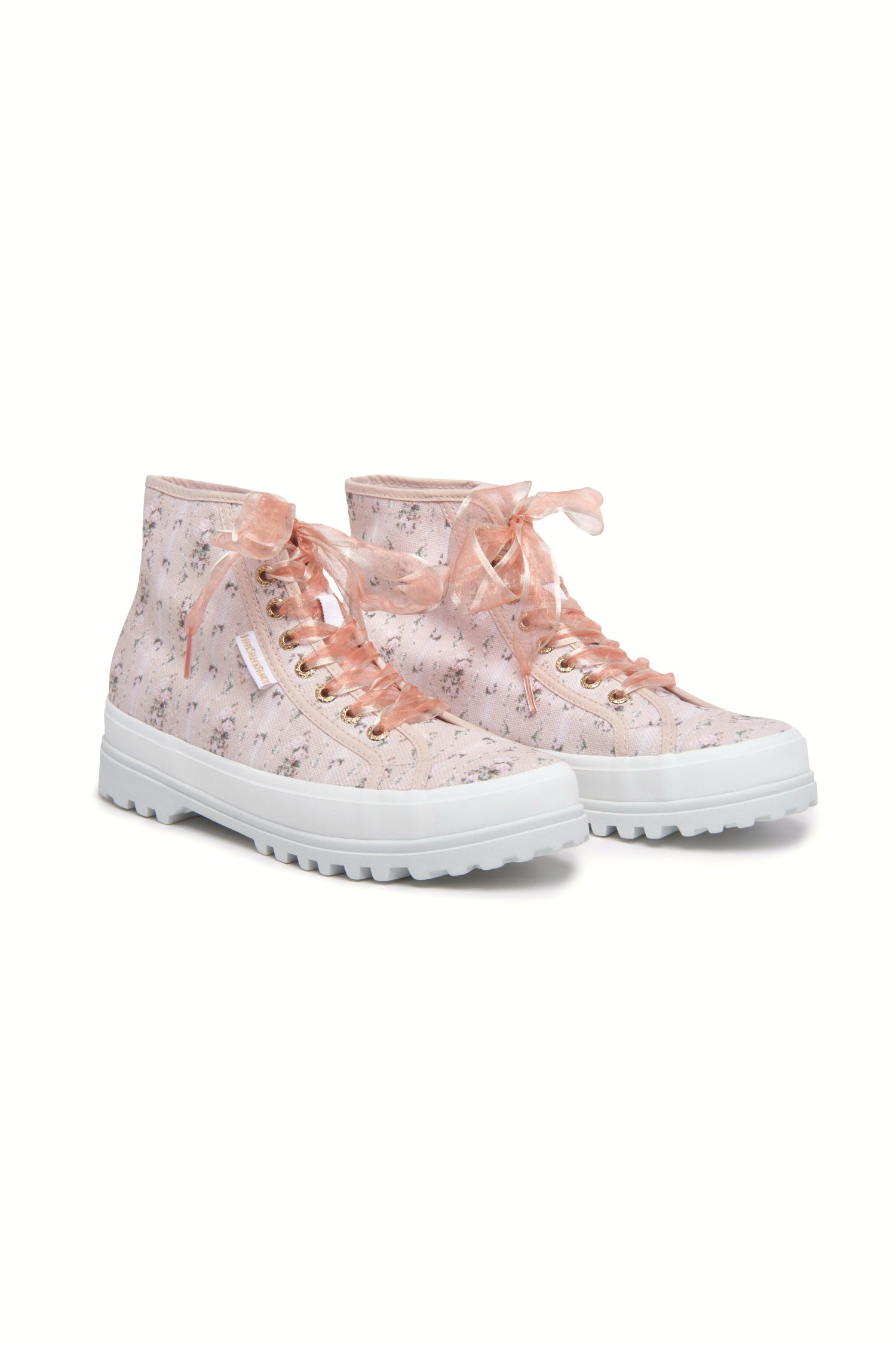 Pink hightop sneakers with florals on printed cotton with pink tulle laces, and gold-tone eyelet details.